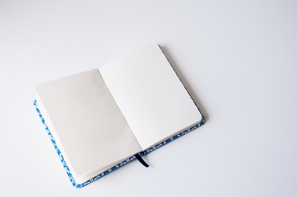 blank notebook on white desk