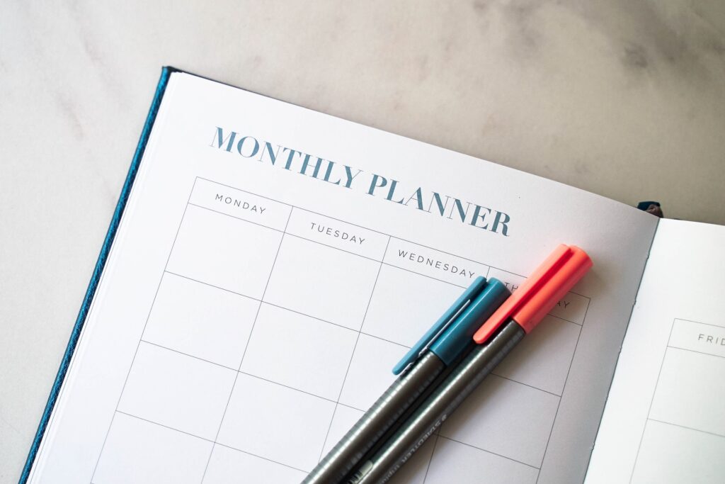 Monthly planner with blue and red pens