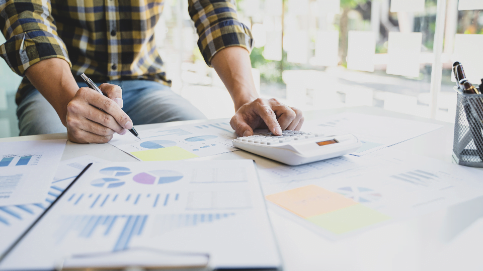 man looking at data and using a calculator