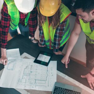 team looking at construction drawings